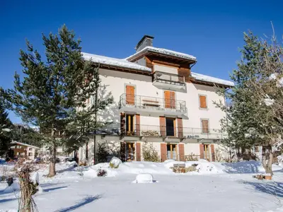 a large house in the snow with trees at Superbe appartement avec cheminée à Argentière - FR-1-343-192 in Chamonix-Mont-Blanc