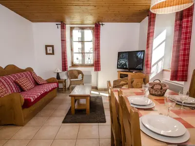 a living room with a couch and a table at Appartement Chamonix 3* - 4 pers. + Animaux admis - FR-1-343-216 in Chamonix-Mont-Blanc
