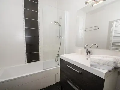 a white bathroom with a sink and a shower at Appartement Chamonix 3* - 4 pers. + Animaux admis - FR-1-343-216 in Chamonix-Mont-Blanc