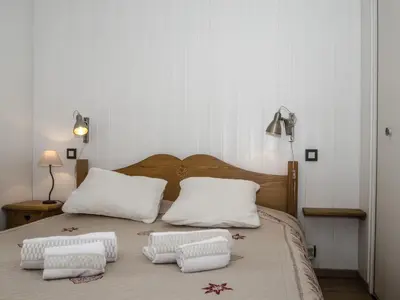 a bedroom with a bed with two pillows on it at Appartement Chamonix 3* - 4 pers. + Animaux admis - FR-1-343-216 in Chamonix-Mont-Blanc