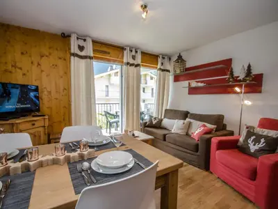 a living room with a table and a couch at Appartement calme 3 étoiles avec Wi-Fi et parking, Chamonix - FR-1-343-212 in Chamonix-Mont-Blanc