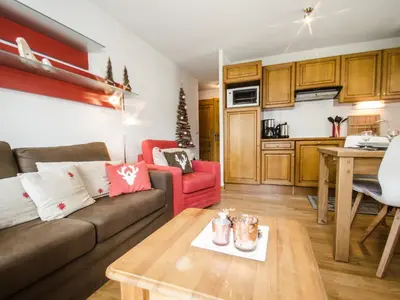 a living room with a couch and a table at Appartement calme 3 étoiles avec Wi-Fi et parking, Chamonix - FR-1-343-212 in Chamonix-Mont-Blanc