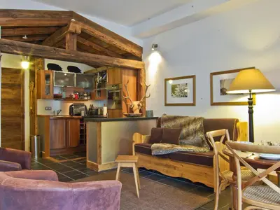 a living room with a couch and a table at Superbe appartement Chamonix pour 4, balcon, vue Mont Blanc - FR-1-343-209 in Chamonix-Mont-Blanc