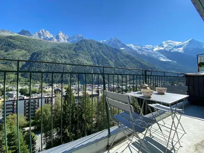 a balcony with a table and a view of mountains at Superbe appartement Chamonix pour 4, balcon, vue Mont Blanc - FR-1-343-209 in Chamonix-Mont-Blanc