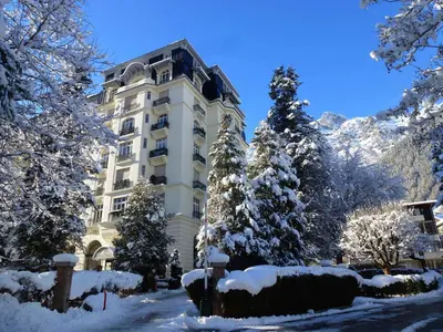 a building with snow covered trees in front of it at Superbe appartement Chamonix pour 4, balcon, vue Mont Blanc - FR-1-343-209 in Chamonix-Mont-Blanc