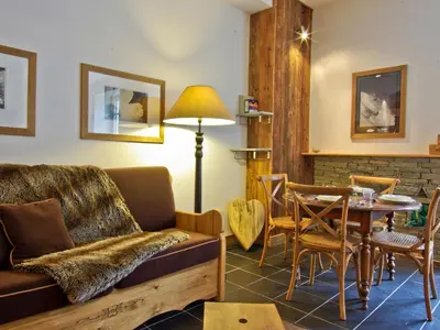 a living room with a couch and a table at Superbe appartement Chamonix pour 4, balcon, vue Mont Blanc - FR-1-343-209 in Chamonix-Mont-Blanc