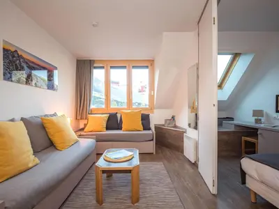 a living room with a couch and a table at Charmant appartement à Chamonix avec parking et wifi - FR-1-343-208 in Chamonix-Mont-Blanc