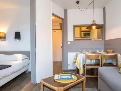 a room with a bed and a dining room with a table at Charmant appartement à Chamonix avec parking et wifi - FR-1-343-208 in Chamonix-Mont-Blanc