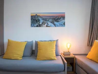 a room with a couch with yellow pillows at Charmant appartement à Chamonix avec parking et wifi - FR-1-343-208 in Chamonix-Mont-Blanc