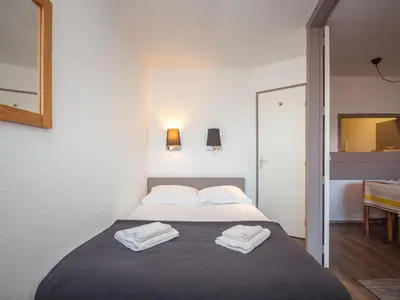 a bedroom with a bed with two towels on it at Charmant appartement à Chamonix avec parking et wifi - FR-1-343-208 in Chamonix-Mont-Blanc