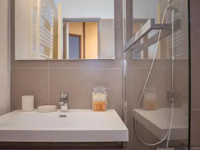 a bathroom with a white sink and a shower at Charmant appartement à Chamonix avec parking et wifi - FR-1-343-208 in Chamonix-Mont-Blanc