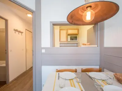 a dining room with a table and a mirror at Charmant appartement à Chamonix avec parking et wifi - FR-1-343-208 in Chamonix-Mont-Blanc