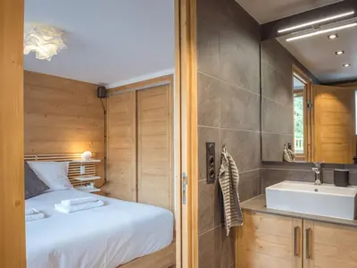 a bathroom with a bed and a sink in a room at Bel appartement 3 étoiles aux Praz de Chamonix, près du téléphérique de la Flégère - FR-1-343-213 in Chamonix-Mont-Blanc