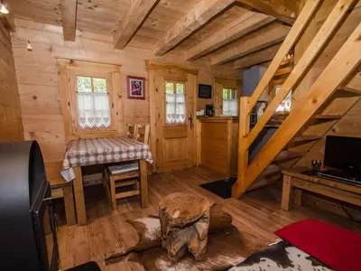 a log cabin with a staircase and a living room at Charmant mazot avec jardin, animaux admis, parking, wifi - FR-1-343-215 in Chamonix-Mont-Blanc