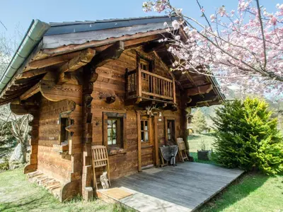 a log cabin with a deck and a balcony at Charmant mazot avec jardin, animaux admis, parking, wifi - FR-1-343-215 in Chamonix-Mont-Blanc