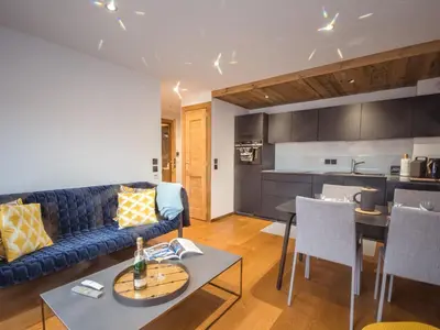 a living room with a couch and a table at Appartement moderne avec balcon et parking à Chamonix - FR-1-343-220 in Chamonix-Mont-Blanc