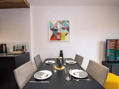 a dining room table with chairs and a black table sidx sidx sidx sidx at Appartement moderne avec balcon et parking à Chamonix - FR-1-343-220 in Chamonix-Mont-Blanc