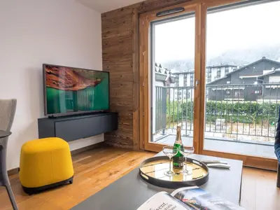 a living room with a large window and a television at Appartement moderne avec balcon et parking à Chamonix - FR-1-343-220 in Chamonix-Mont-Blanc