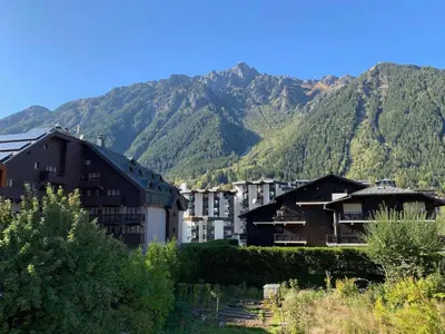 a group of buildings in front of a mountain at Appartement moderne avec balcon et parking à Chamonix - FR-1-343-220 in Chamonix-Mont-Blanc