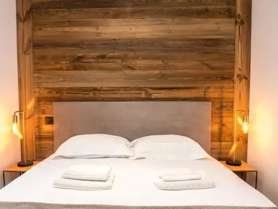 a bed with two white towels on top of it at Appartement moderne avec balcon et parking à Chamonix - FR-1-343-220 in Chamonix-Mont-Blanc