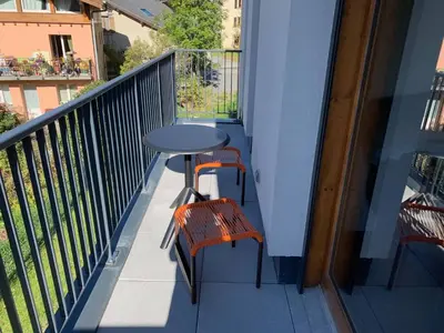a balcony with a table and two chairs on it at Appartement moderne avec balcon et parking à Chamonix - FR-1-343-220 in Chamonix-Mont-Blanc