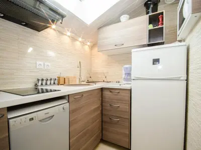 a kitchen with a white refrigerator and wooden cabinets at Bel appartement 4 pers avec parking et balcon à Chamonix - FR-1-343-214 in Chamonix-Mont-Blanc