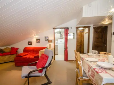 a living room with a red couch and a table at Bel appartement 4 pers avec parking et balcon à Chamonix - FR-1-343-214 in Chamonix-Mont-Blanc