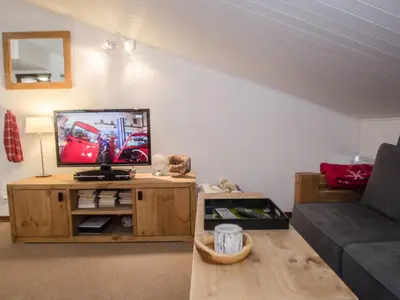a living room with a tv and a couch at Bel appartement 4 pers avec parking et balcon à Chamonix - FR-1-343-214 in Chamonix-Mont-Blanc
