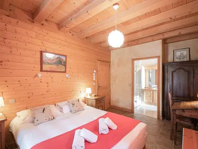 a bedroom with a large bed in a wooden room at Chalet de charme à Chamonix avec WiFi et parking privé pour 12 pers. - FR-1-343-226 in Chamonix-Mont-Blanc