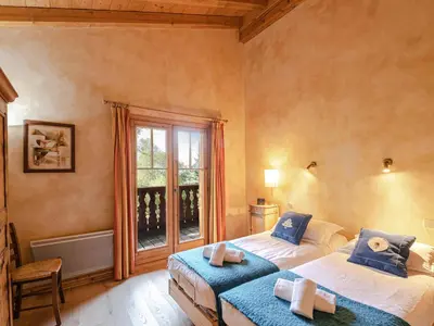 a bedroom with two beds and a window at Chalet de charme à Chamonix avec WiFi et parking privé pour 12 pers. - FR-1-343-226 in Chamonix-Mont-Blanc
