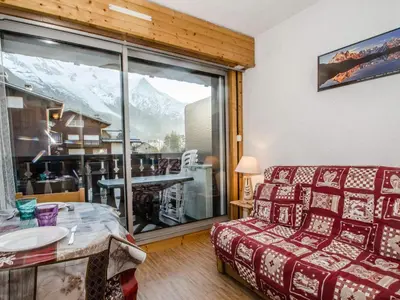 a living room with a couch and a large window at Studio cosy 3 pers, ski-in/ski-out Chamonix avec wifi et animaux admis - FR-1-343-217 in Chamonix-Mont-Blanc
