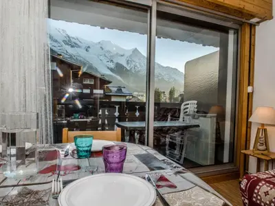 a dining room table with a view of a mountain at Studio cosy 3 pers, ski-in/ski-out Chamonix avec wifi et animaux admis - FR-1-343-217 in Chamonix-Mont-Blanc