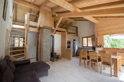 a living room with a couch and a table at Le Lac - Servoz - Appartement paisible de 70m² in Les Houches