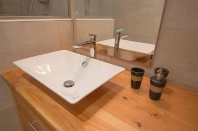 a bathroom with a white sink and a mirror at Le Lac - Servoz - Appartement paisible de 70m² in Les Houches