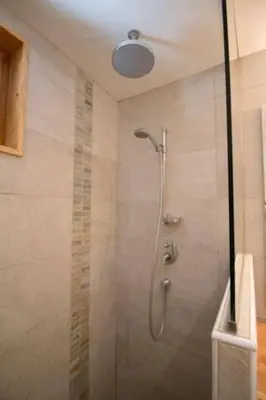 a shower with a glass door in a bathroom at Le Lac - Servoz - Appartement paisible de 70m² in Les Houches