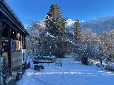 a snow covered yard next to a house at Le Chalet de Bémont in Samoëns