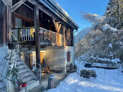 a log cabin in the snow with a balcony at Le Chalet de Bémont in Samoëns