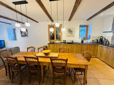 a dining room with a wooden table and chairs at Le Chalet de Bémont in Samoëns
