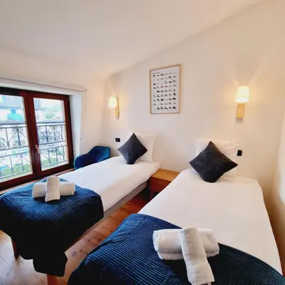 a room with two beds with towels on them at ALPES IV - Hyper Centre - Parking - 40m² in Chamonix-Mont-Blanc
