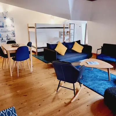 a living room with a couch and a table and a bed at ALPES IV - Hyper Centre - Parking - 40m² in Chamonix-Mont-Blanc