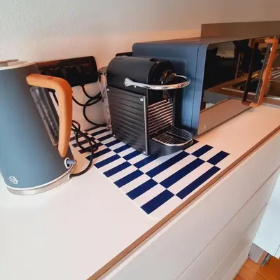 a kitchen counter with a coffee maker and a microwave at ALPES IV - Hyper Centre - Parking - 40m² in Chamonix-Mont-Blanc