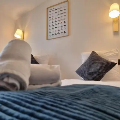 a bedroom with a bed with blue sheets and pillows at ALPES IV - Hyper Centre - Parking - 40m² in Chamonix-Mont-Blanc