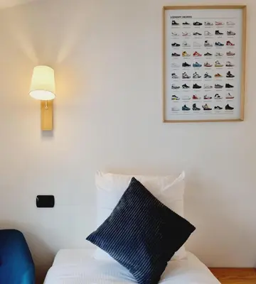a room with a bed and a picture on the wall at ALPES IV - Hyper Centre - Parking - 40m² in Chamonix-Mont-Blanc
