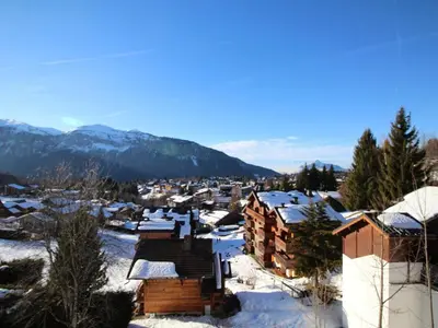 a town covered in snow with mountains in the background at Studio spacieux 5 pers avec parking aux Carroz d'Arâches - FR-1-572-192 in Arâches-la-Frasse