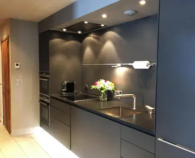 a kitchen with a sink and a black wall at Chamonix Bellevue in Chamonix-Mont-Blanc