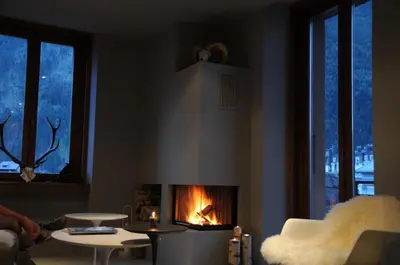 a living room with a fire in a fireplace at Chamonix Bellevue in Chamonix-Mont-Blanc