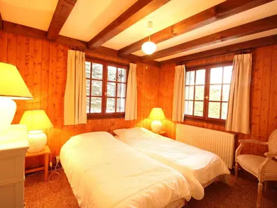 a bedroom with a large bed and two windows at Chalet 4 chambres sur pistes débutants avec balcon et parking, à 350m des commerces - FR-1-572-196 in Arâches-la-Frasse
