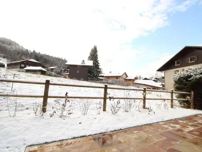 a fence covered in snow next to a house at Chalet 4 chambres sur pistes débutants avec balcon et parking, à 350m des commerces - FR-1-572-196 in Arâches-la-Frasse