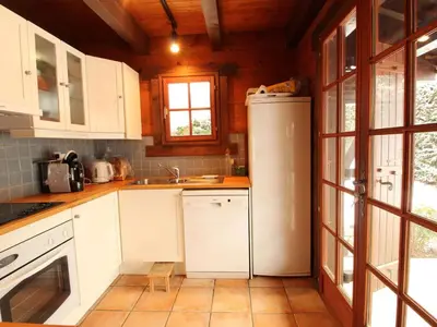 a kitchen with white cabinets and a refrigerator at Chalet 4 chambres sur pistes débutants avec balcon et parking, à 350m des commerces - FR-1-572-196 in Arâches-la-Frasse