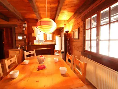 a dining room with a wooden table in a kitchen at Chalet 4 chambres sur pistes débutants avec balcon et parking, à 350m des commerces - FR-1-572-196 in Arâches-la-Frasse